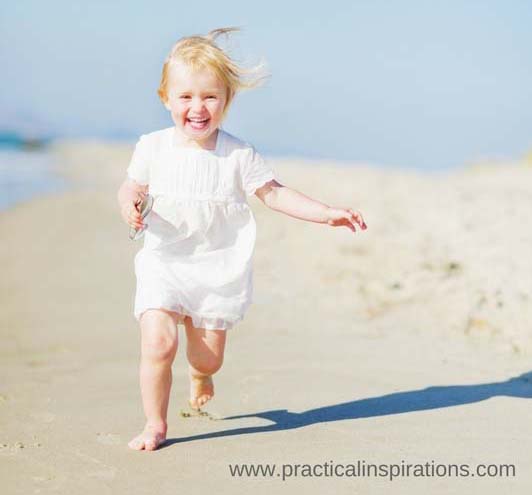 baby running on beach